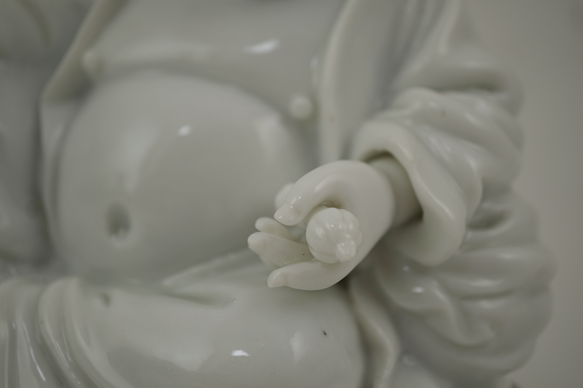 A Chinese blanc-de-chine seated figure of Budai, 18th/19th century